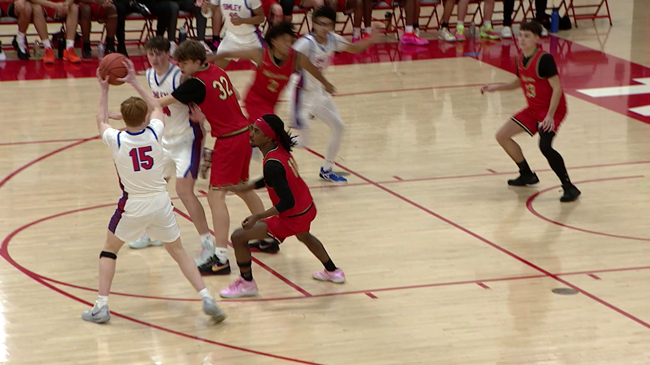 basketball players in a group trying to get the ball