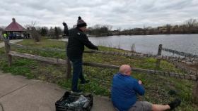 people sitting in front of a fence