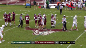 football players walking back to their positions after a play