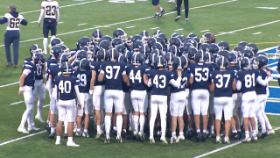 football players jumping together as a group before game starts