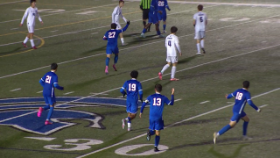 soccer players running on a soccer field