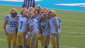 football players in huddle