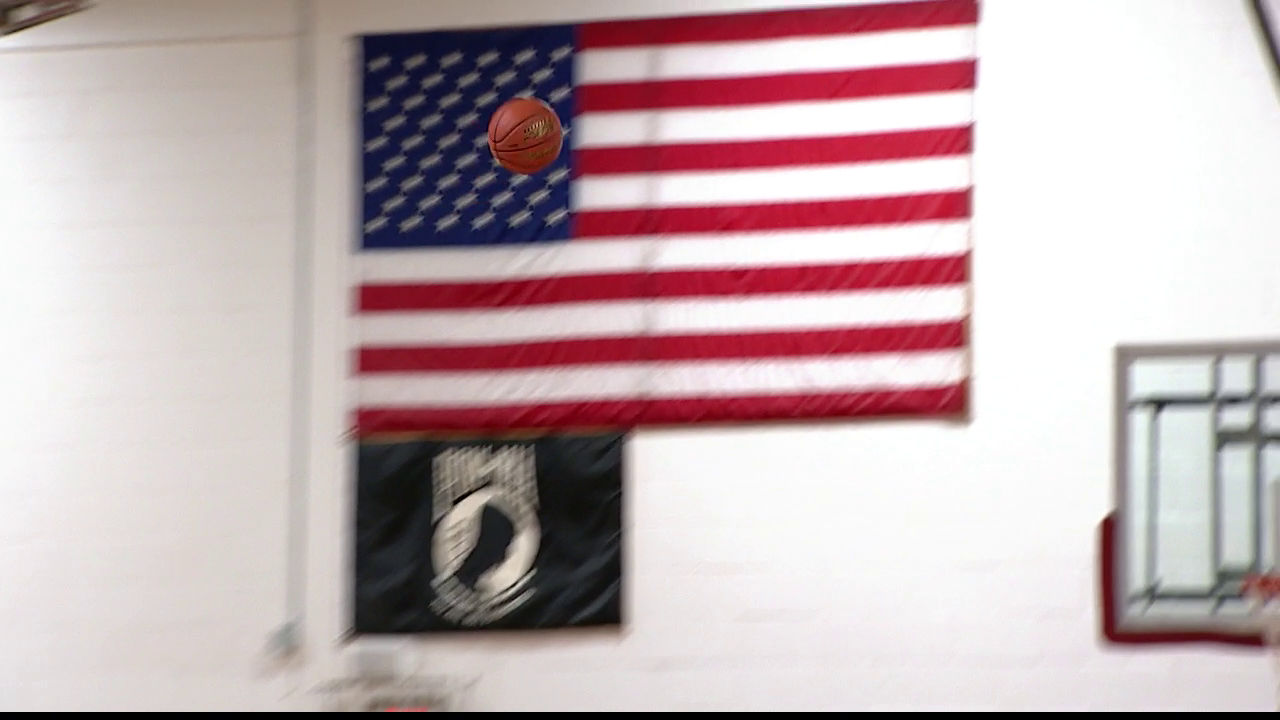 basketball in the air going towards basket