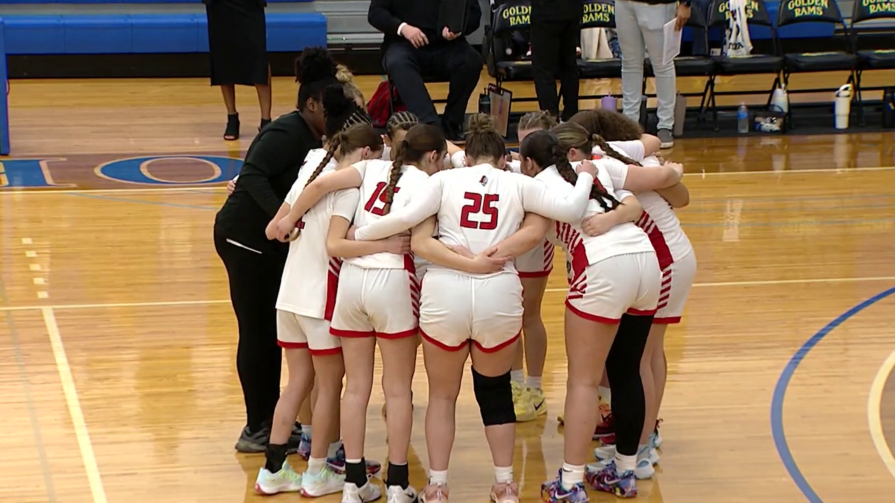 basketball players in a huddle before the game