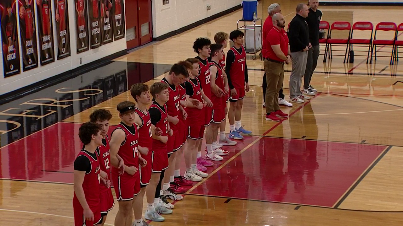 basketball players lined up during the national anthem