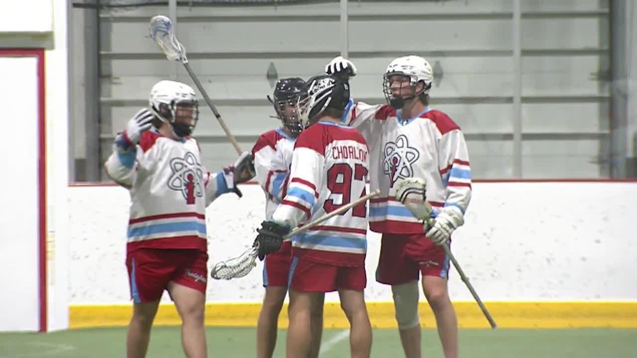 group of lacrosse players talking between plays