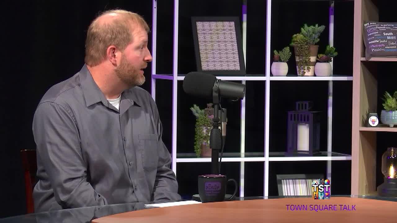 Matt Carter talking into a microphone